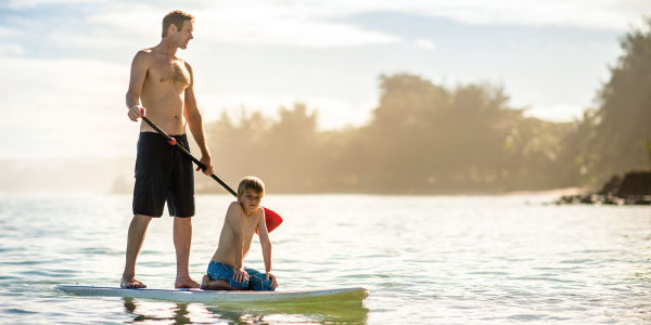 Father and son on paddle board